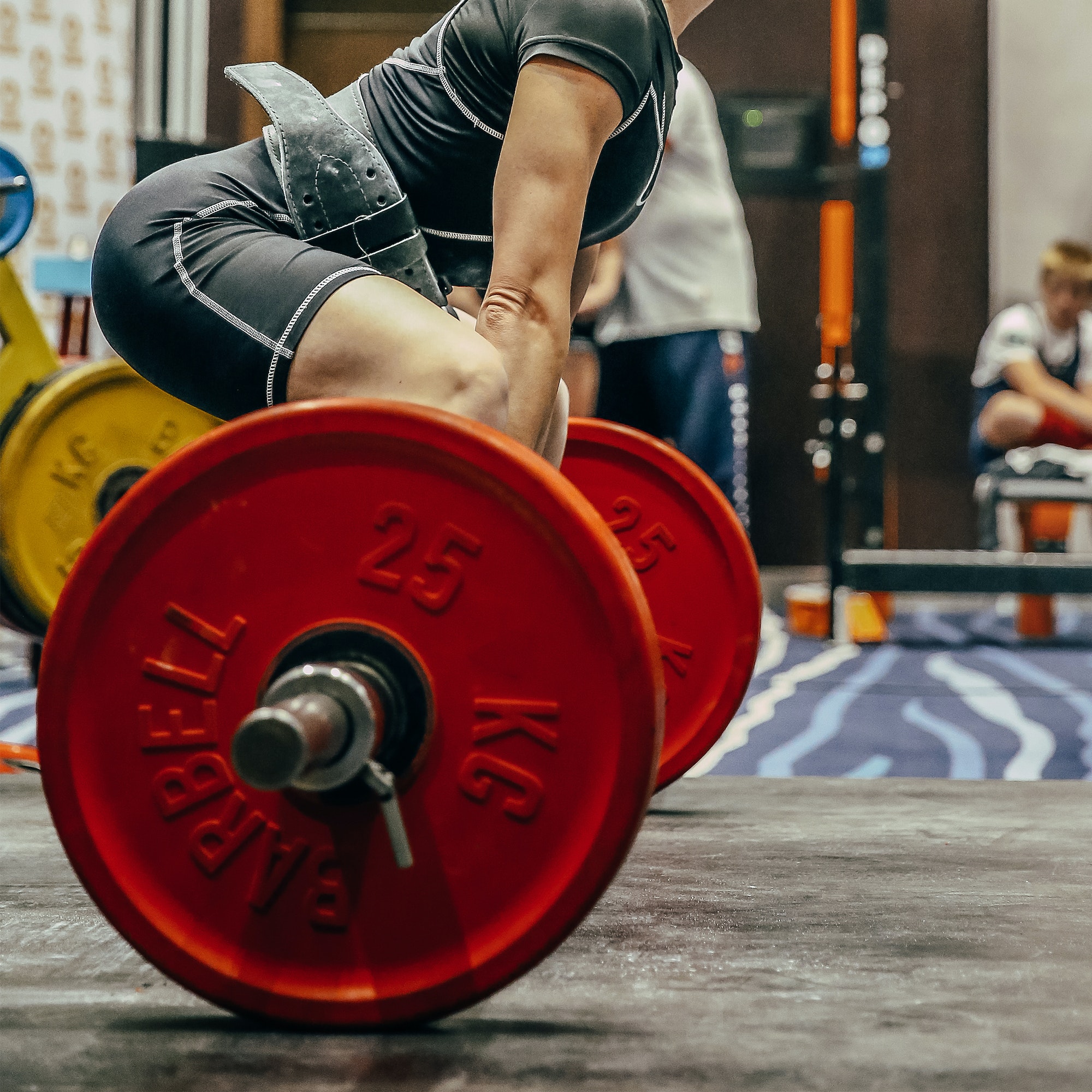 side view female athlete perform deadlift in powerlifting competition power sports games